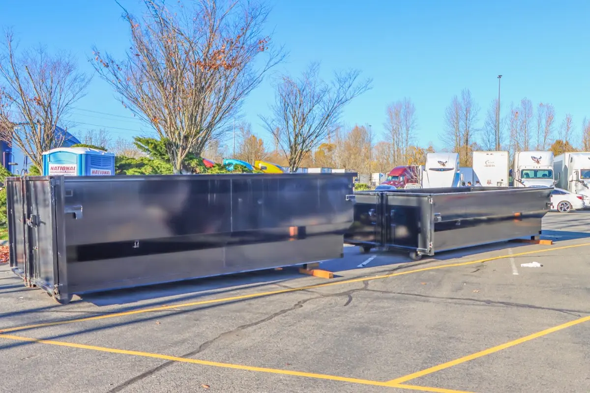 Professional dumpster rental service with roll-off container on residential driveway in Oregon City